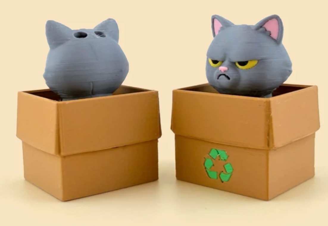 Front and back views of the same gray British Shorthair Cat Box, with a Recycling box example. Any box style can be selected.