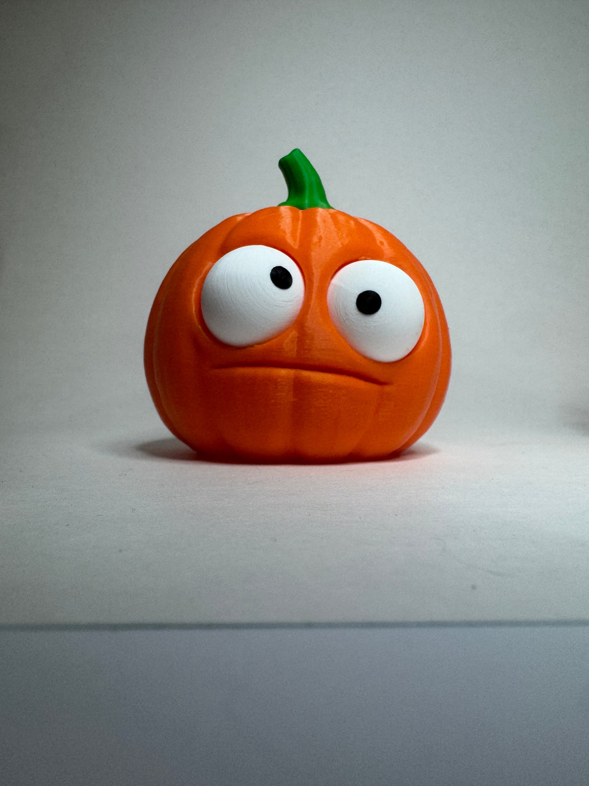 Orange Goofy Pumpkins with green stems and posable eyes, round shape