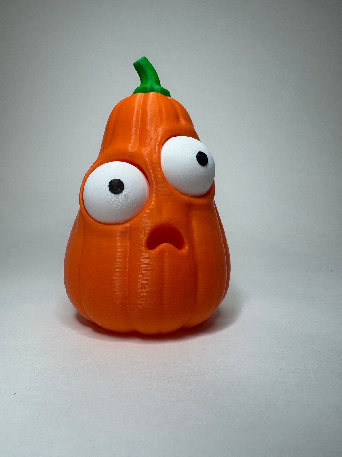 Orange Goofy Pumpkins with green stems and posable eyes, tall shape
